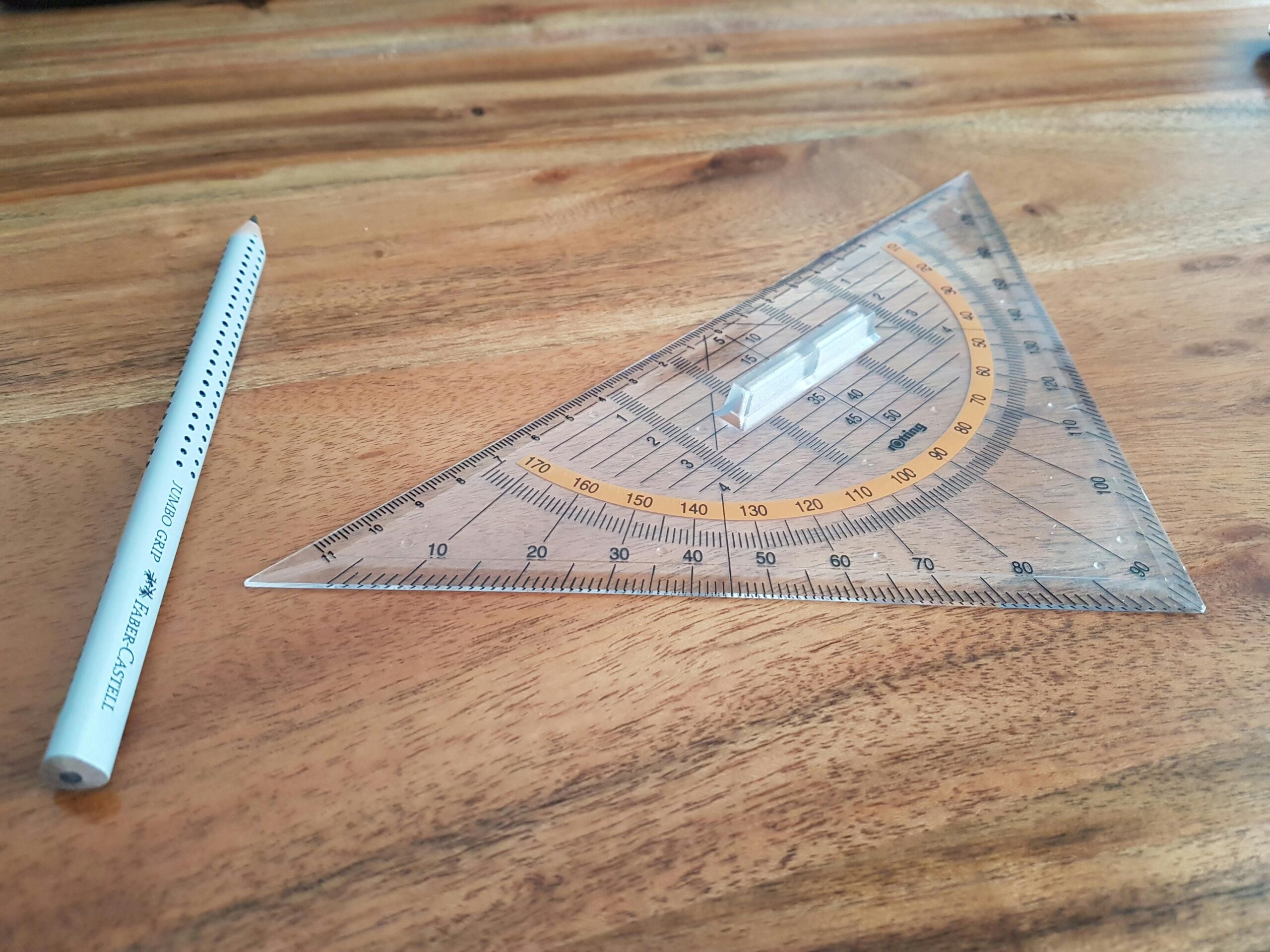 Gray Pencil and Triangular Ruler on Brown Wooden Surface